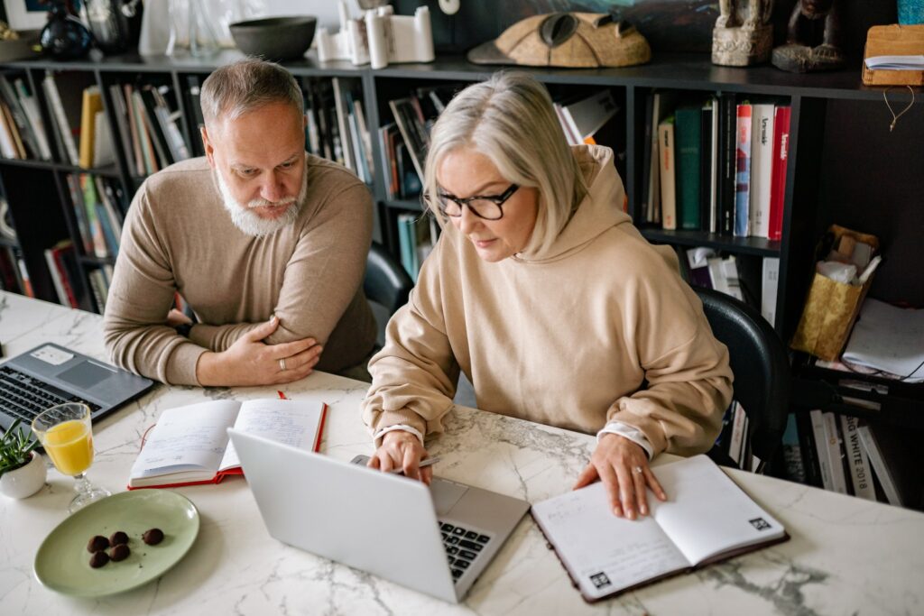 A Man and a Woman Using Laptops